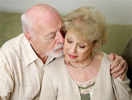 A senior man and wife deeply in love.  She is upset and he is comforting her. Stock Photo - Budget Royalty-Free & Subscription, Code: 400-03969135