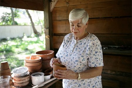 A senior lady gardening in her potting shed. Stock Photo - Budget Royalty-Free & Subscription, Code: 400-03969235