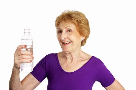 Fit senior lady in a leotard about to drink a bottle of water.  Isolated on white. Photographie de stock - Aubaine LD & Abonnement, Code: 400-03969336