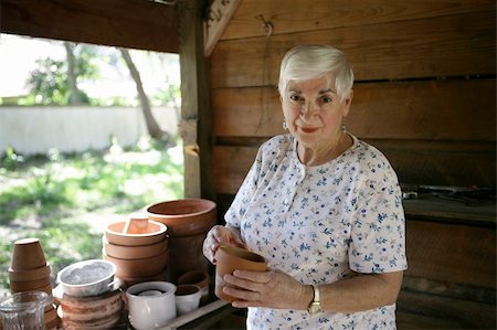 A sweet senior lady gardening in her potting shed. Stock Photo - Budget Royalty-Free & Subscription, Code: 400-03969339