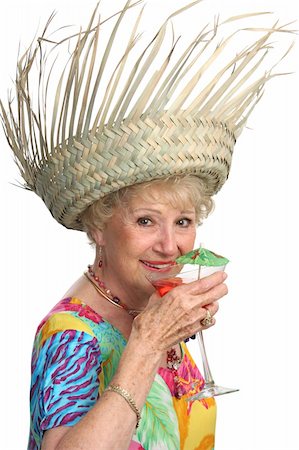 A beautiful senior lady enjoying a tropical cocktail on a cruise.  Isolated. Stock Photo - Budget Royalty-Free & Subscription, Code: 400-03969347