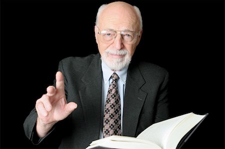 simsearch:700-00195691,k - A handsome older man either teaching or preaching from a book.  Isolated on black. Photographie de stock - Aubaine LD & Abonnement, Code: 400-03969455