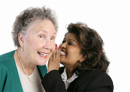 Two businesswomen gossiping and trading secrets.  Isolated on white. Stock Photo - Budget Royalty-Free & Subscription, Code: 400-03969470