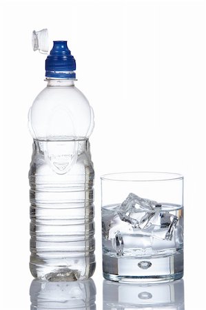 dehydrated - Bottle and glass of mineral water with droplets reflected on white background Foto de stock - Super Valor sin royalties y Suscripción, Código: 400-03969684