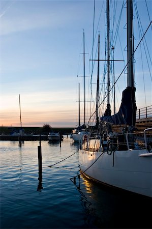 simsearch:400-04793526,k - Yacht anchored on a marina in Malmö, Sweden at late afternoon light. Stock Photo - Budget Royalty-Free & Subscription, Code: 400-03969731