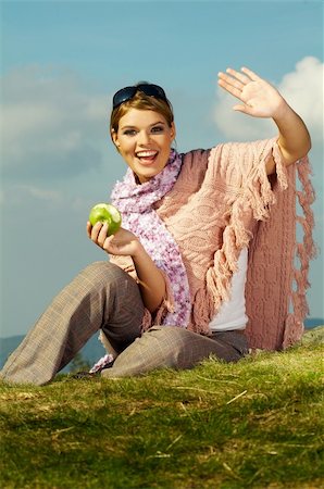 Young business woman relaxing on meadow, holding green fresh apple Stock Photo - Budget Royalty-Free & Subscription, Code: 400-03960761