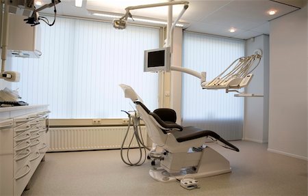 dentist with patient in exam room - The interior of a dentist office Stock Photo - Budget Royalty-Free & Subscription, Code: 400-03962904