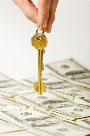 simsearch:400-04529024,k - Hand holding a golden key over dollar background Stock Photo - Budget Royalty-Free & Subscription, Code: 400-03978136