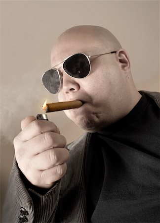 simsearch:400-05207678,k - The Mobster, Boss, Head Honcho, Top Dog...  An image of the Man in charge, smoking a cigar.  Focus is on the cigar, while mobster is de-saturated for meaner look. Stock Photo - Budget Royalty-Free & Subscription, Code: 400-03979328