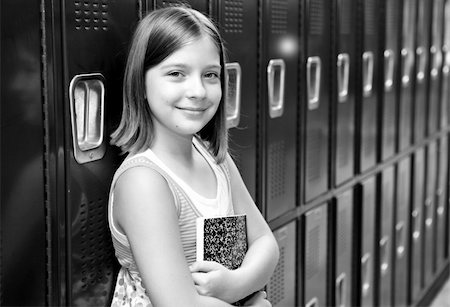 simsearch:614-06973669,k - A pretty school girl leaning against her locker. Black and white. Stock Photo - Budget Royalty-Free & Subscription, Code: 400-03970414