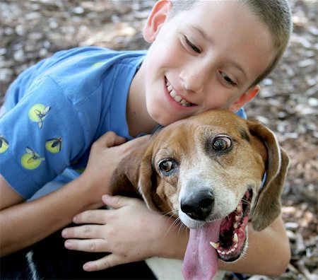 A beagle enjoying a hug from an adorable little boy.  Focus on dog's face. Stock Photo - Budget Royalty-Free & Subscription, Code: 400-03970439