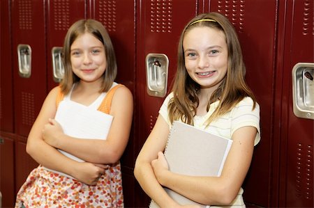 simsearch:614-06973669,k - Two cute school girls leaning against their lockers. Stock Photo - Budget Royalty-Free & Subscription, Code: 400-03970433
