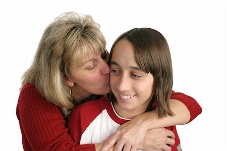 A mother giving a kiss on the cheek to her adolescent son.  Isolated. Stock Photo - Budget Royalty-Free & Subscription, Code: 400-03970491