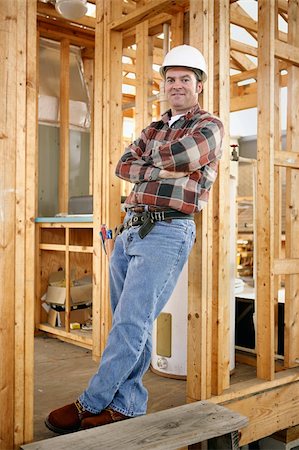 simsearch:700-02071118,k - Full body view of a handsome construction worker leaning casually against a wood framed building.  Authentic construction worker on actual construction site. Stock Photo - Budget Royalty-Free & Subscription, Code: 400-03971085