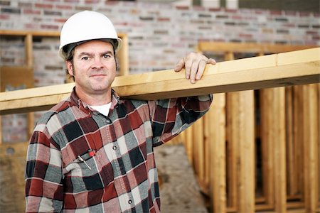 simsearch:700-02071118,k - A construction day laborer carrying wood beams.  Authentic construction worker on an actual construciton site. Stock Photo - Budget Royalty-Free & Subscription, Code: 400-03971103