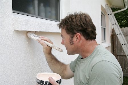 A painter edging around an exterior window with a brush. Stock Photo - Budget Royalty-Free & Subscription, Code: 400-03971138