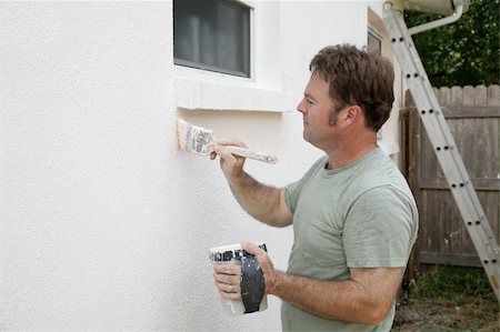 A house painter edging around a window with a brush.  Room for text. Stock Photo - Budget Royalty-Free & Subscription, Code: 400-03971130