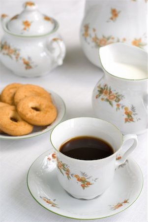 simsearch:600-07067016,k - Coffee (or tea) set on the table - cup of coffee on the front (focus on it) cookies, milk jug and sugar bowl behind. Stock Photo - Budget Royalty-Free & Subscription, Code: 400-03971868
