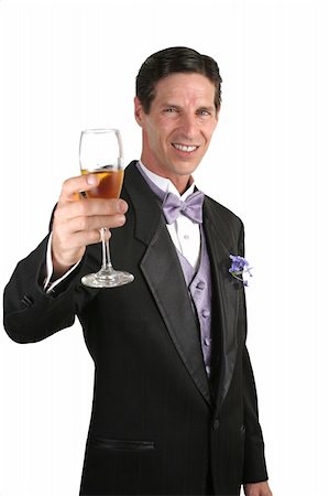 simsearch:846-05646372,k - A handsome man in a tuxedo making a toast with champagne. Photographie de stock - Aubaine LD & Abonnement, Code: 400-03972381