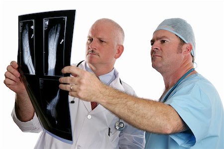 simsearch:649-07709952,k - Two doctors examing the xray of a foot.  (focus on young doctor in foreground) Stock Photo - Budget Royalty-Free & Subscription, Code: 400-03972399