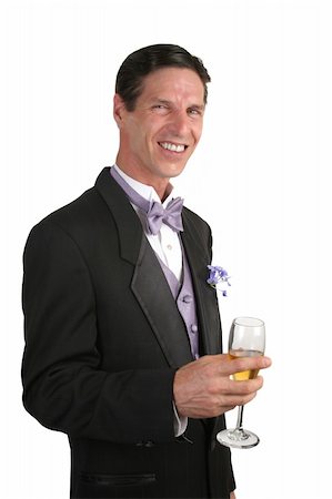 simsearch:846-05646372,k - A handsome man wearing a tuxedo and drinking a glass of champagne. Photographie de stock - Aubaine LD & Abonnement, Code: 400-03972445