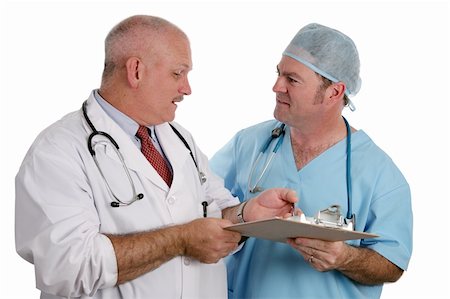 simsearch:649-07064718,k - An older doctor instructs an intern as they discuss a patient's medical history.  Isolated. Stock Photo - Budget Royalty-Free & Subscription, Code: 400-03972462