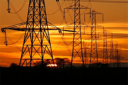 Sun setting behind a row of electricity pylons Stock Photo - Budget Royalty-Free & Subscription, Code: 400-03972871