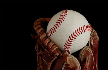 Close up of a baseball glove isolated on a black background Stock Photo - Budget Royalty-Free & Subscription, Code: 400-03989237