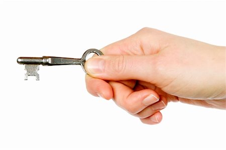 A concept image of a womans hand holding a key. Isolated on white with clipping mask. Foto de stock - Super Valor sin royalties y Suscripción, Código: 400-03983605