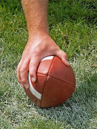 pigskin - a football players hand on the ball Stock Photo - Budget Royalty-Free & Subscription, Code: 400-03994019