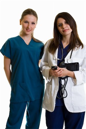 simsearch:400-07411030,k - Two woman healthcare workers one wearing a doctors lab coat holding a sphynometer the other in scrubs standing on white Stock Photo - Budget Royalty-Free & Subscription, Code: 400-03994895