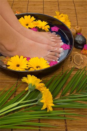 Spa treatment with aromatic gerbera daisies, healing stones, olive oil soaps and herbal water Stock Photo - Budget Royalty-Free & Subscription, Code: 400-03994968