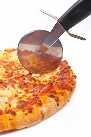 simsearch:400-04479187,k - Tasty Italian pizza and cutter with soft shadow on white background. Shallow DOF Stock Photo - Budget Royalty-Free & Subscription, Code: 400-03997083