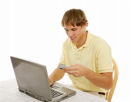 simsearch:400-04505681,k - College age young man using a credit card to shop on the internet.  Isolated on white. Stock Photo - Budget Royalty-Free & Subscription, Code: 400-03997996