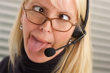 simsearch:400-03933798,k - Goofy businesswoman talks on her phone headset. Stock Photo - Budget Royalty-Free & Subscription, Code: 400-03999651