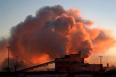 steam vent - Factory at dawn on a cold day, with steam or smoke billowing from its chimneys. Stock Photo - Budget Royalty-Free & Subscription, Code: 400-03991657