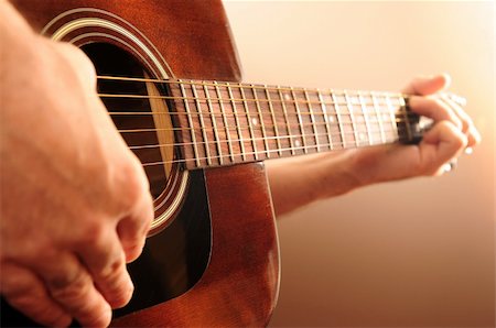 fret - Hands of a person playing an acoustic guitar Stock Photo - Budget Royalty-Free & Subscription, Code: 400-03992500