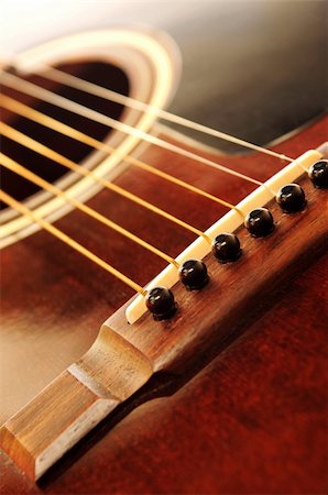 Acoustic guitar bridge and strings close up Stock Photo - Budget Royalty-Free & Subscription, Code: 400-03993624