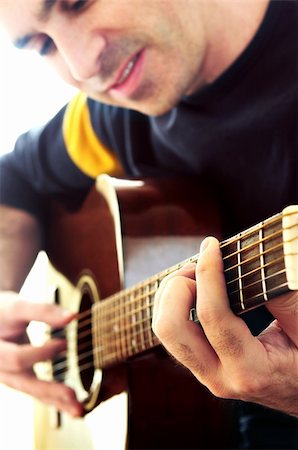 fret - Man playing a musical instrument accoustic guitar Stock Photo - Budget Royalty-Free & Subscription, Code: 400-03993622