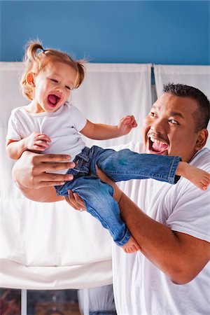 Father Lifting Daughter Up in the Air Stock Photo - Premium Royalty-Free, Code: 600-04926439