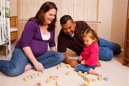 Family sitting on Floor Playing with Building Blocks Stock Photo - Premium Royalty-Free, Code: 600-04929242
