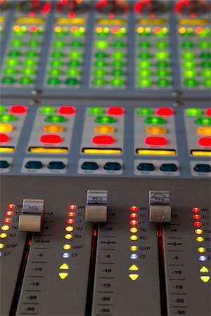 recording studio - Looking down at a professional music mixing desk lit up, close up Stock Photo - Premium Royalty-Free, Code: 600-05451171