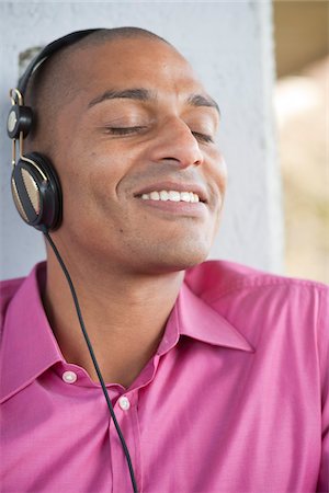 Close-up Portrait of Man using Headphones Stock Photo - Premium Royalty-Free, Code: 600-05609740