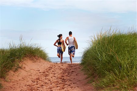 footsteps beach summer - Young Woman and Young Man holding Skimboards while Running to Beach, PEI, Canada Stock Photo - Premium Royalty-Free, Code: 600-05641654