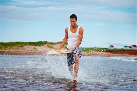 dexterity - Young Man Riding Skimboard near Shoreline, PEI, Canada Stock Photo - Premium Royalty-Free, Code: 600-05641657