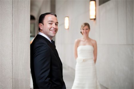 Portrait of Groom with Bride in Background Stock Photo - Premium Royalty-Free, Code: 600-05786579