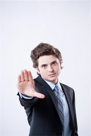 Portrait of Young Businessman using Hand Gesture Fotografie stock - Premium Royalty-Free, Codice: 600-05973096