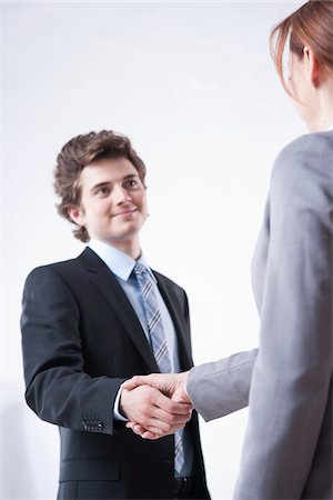 simsearch:600-05973117,k - Young Businessman Shaking Hands with Businesswoman Stock Photo - Premium Royalty-Free, Code: 600-05973105