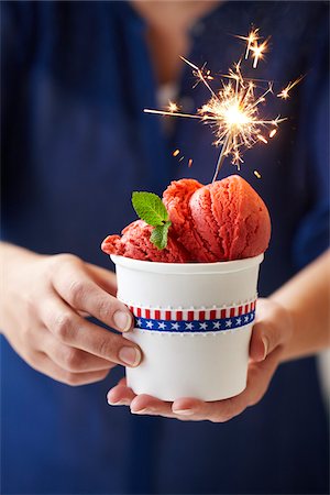 simsearch:600-03768654,k - Woman Holding Cup of Berry Ice Cream with Sparkler Stock Photo - Premium Royalty-Free, Code: 600-06059754