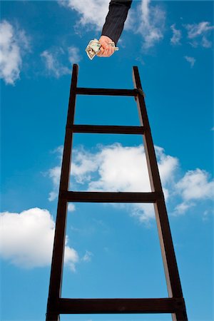 reach the top - Businessman with Fist of Cash at Top of Ladder Stock Photo - Premium Royalty-Free, Code: 600-06144766